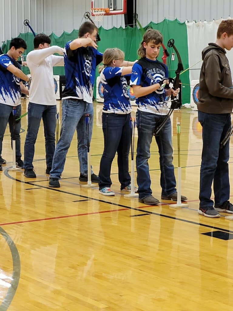 students in gym playing Archery 