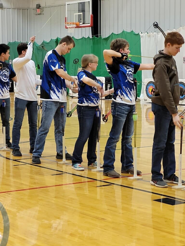 students in gym playing Archery 